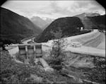 an image of a dam and mountains and hills