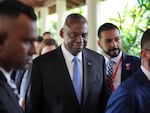 U.S. Secretary of Defense Lloyd Austin, center, walks out after a bilateral meeting with China's Defense Minister Dong Jun on the sidelines of the 21st Shangri-La Dialogue summit at the Shangri-La Hotel in Singapore on Friday.