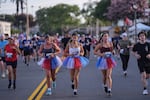Runners in patriotic-colored tutus participate in a run on Independence Day in Huntington Beach, Calif. on Saturday.