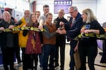 Left to right, Brian Michael Bendis, Andru Morgan, David F. Walker, Diana Schutz, Michael Ring, Matt Roberts, Dave Schrott, Robert Sacks, Mike Rosen, and Multnomah County Commissioner Julia Brim Edwards cut the ceremonial ribbon at the debut of the Northwest Museum of Cartoon Arts on Nov. 3, 2025 in Portland.