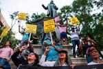 Demonstrators hold signs in front of the statue of Confederate General Albert Pike on Aug. 13, 2017, in Washington, DC., during a vigil in response to the death of a counter-protestor in the "Unite the Right" in Charlottesville, Va.