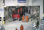 Heavy machinery removes debris at AEON Mall, which was damaged by an explosion following an earthquake, in Kashima, Kumamoto Prefecture, southern Japan, Friday, July 31, 2026.