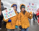 Two kids hold signs at a parent-led rally in Albany on Sunday, Nov. 17, 2024, supporting Greater Albany Public School teachers on strike.