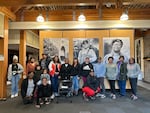 In this photo provided by People of Color Outdoors, group members stand in front of the Tillamook Forest Center exhibit "Roots: We Been Here," on June 15, 2024. The exhibit includes a film that features Pamela Slaughter, the group's founder.