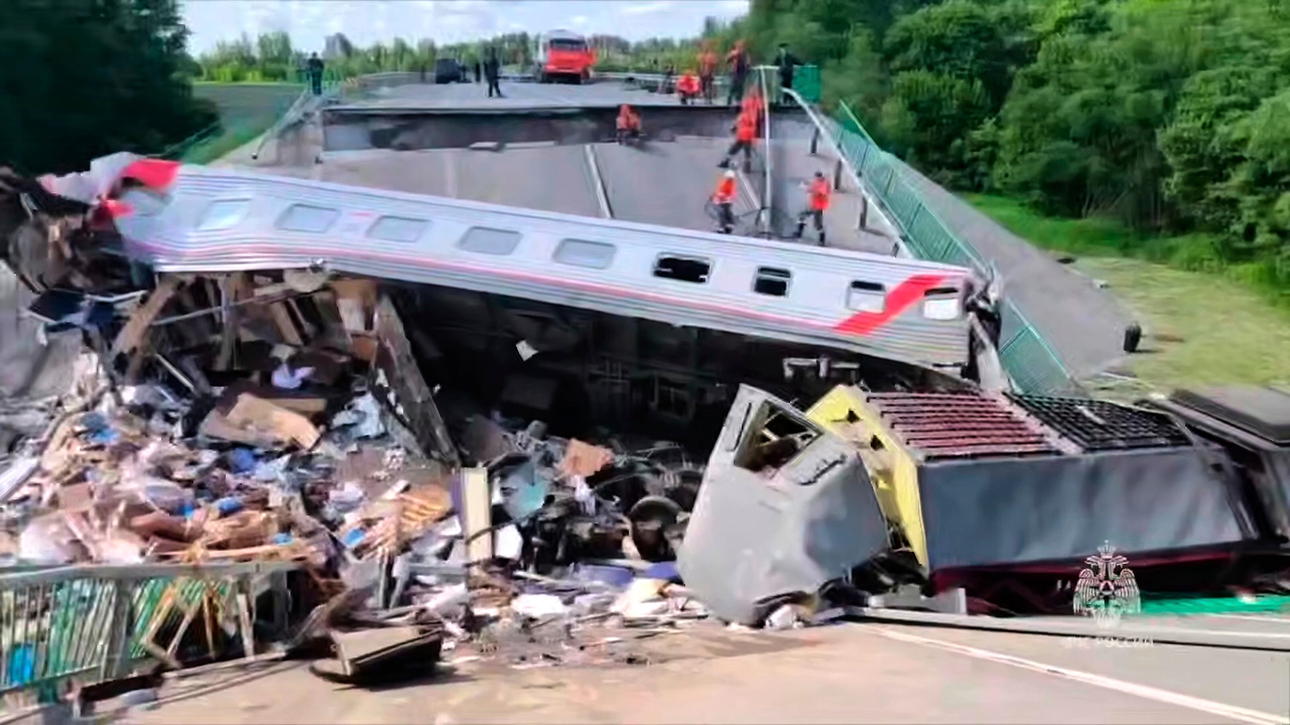 In this photo released by Russian Emergency Ministry Press Service telegram channel on Sunday, June 1, 2025, emergency employees work at a damaged bridge in Russia's Bryansk region, which borders Ukraine.