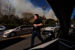 A person flees from an advancing wildfire in the Pacific Palisades neighborhood of Los Angeles.