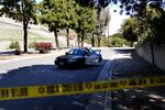 A Sheriff's car blocks a road near a rollover accident involving golfer Tiger Woods Tuesday, Feb. 23, 2021, in in the Rancho Palos Verdes section of Los Angeles. Woods had to be extricated from the vehicle with the "jaws of life" tools, the Los Angeles County Sheriff's Department said in a statement. (AP Photo/Ashley Landis)