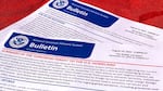 A document with U.S. government seals on it reads "BULLETIN" in large font, and then "summary of the terrorism threat to the U.S. homeland" in smaller red font. Additional writing is too small to read.