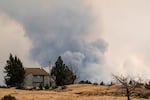 The Bench Fire burning in the distance from Highway 26 near Warm Springs, Ore., on July 30, 2026.