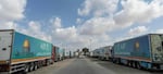Aid convoy trucks wait at the Rafah border crossing for clearance to enter Gaza on Thursday in North Sinai, Egypt. The aid convoy, organized by a group of Egyptian NGOs, set off Saturday from Cairo for the Gaza-Egypt border crossing at Rafah.