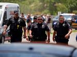 Police walk near Robb Elementary School following the shooting on Tuesday.