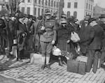 This 1918 photograph shows "enemy aliens" being corralled by Secret Service operatives at Gloucester, N.J., on their way to internment in the South.