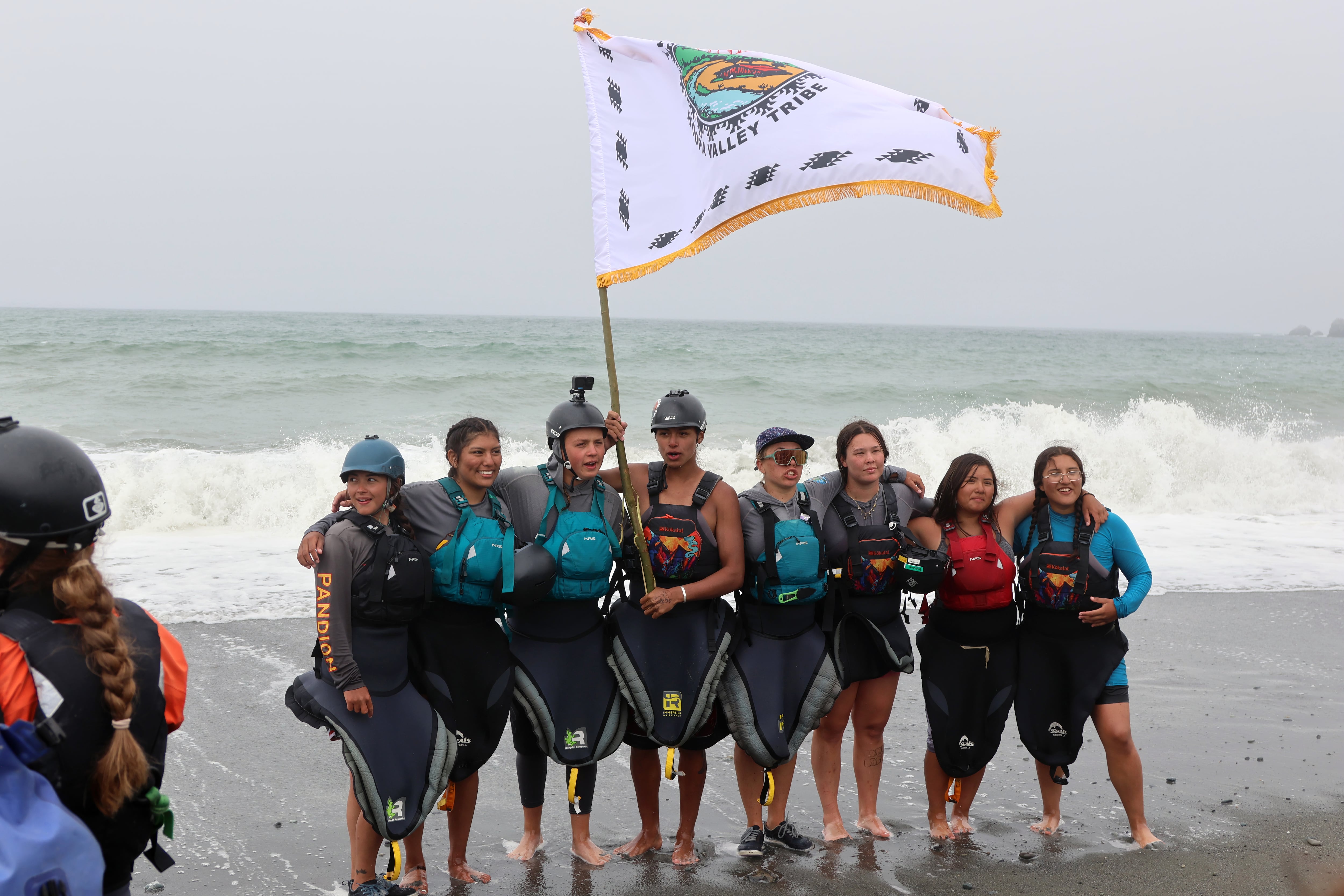 A group of youth celebrate as they pose for their photo after completing the historic descent down the newly undammed Klamath River.