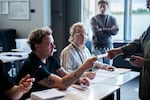 An election worker assists a voter at a polling station inside Reykjavik City Hall in Reykjavik, Iceland, Saturday, Aug. 29, 2026.