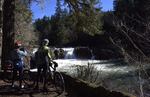 Eugene residents Virginia Xing and Tom Sanborn stop to take a photo at Wildwood Falls on the Row River on Feb. 27, 2026. The area is popular with bicyclists, and those passing through to visit the Umpqua National Forest and Bohemia Mines. Community members are trying to raise funds to build a fire station to improve emergency response for locals and visitors.