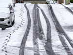 A few tire tracks and footprints lead down a hill in the Bethany area, April 11, 2022. 