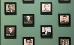 A wall at the exhibit features photos of Chinese Oregonians, many of which were taken during the immigration process.