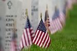 FILE - In this May 31, 2021 file photo, flags and tributes mark the Memorial Day holiday at Fort Logan National Cemetery in southeast Denver. The number of U.S. military suicides jumped by 15% last year, fueled by significant increases in the Army and Marine Corps that senior leaders called troubling. They urged more effort to reverse the trend.