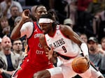 Portland Trail Blazers forward Jerami Grant, right, drives to the hoop against New Orleans Pelicans guard Javonte Green during the second half of an NBA basketball game Sunday, Oct. 27, 2024, in Portland, Ore.