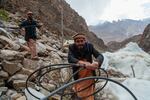 Men dismantle the pipes and nozzles that created a frozen fountain, or ice stupa, that they built over the village of Pari. The fountain is formed from mist sprayed into the air in winter. In spring it melts and provides needed water for farmers. They take the pipes down in summer to ensure the infrastructure isn't damaged by the sun.