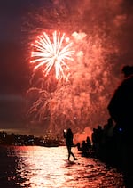 Spectators watch the fireworks show at Sellwood Riverfront Park in Portland, Ore., July 4, 2025. 