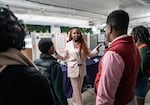 At the National STEM Festival, 12th-grader Treyonna Sullivan talks with visitors about her "Project Poop," created to encourage pet owners in her community to dispose of their pet's waste.