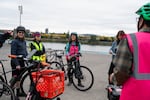 (Left to right) Commuter Karin Wohlert, and Portland Bureau of Transportation volunteer Lauren Jin and employee Sarah Goforth, talk with others at Salmon Street Springs.