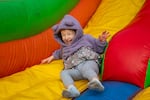 Calli's daughter slides down an inflatable slide at a recent family outing to Siemers Farm in Mead, Wash. 