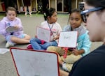 Teacher Angelica Alaniz works with students on reading skills during a bilingual summer learning program at Imlay Elementary School in Hillsboro, Ore., on Wednesday, July 31, 2024.