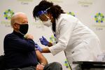 President-elect Joe Biden receives his first dose of the coronavirus vaccine at ChristianaCare Christiana Hospital in Newark, Del., Monday, Dec. 21, 2020, from nurse practitioner Tabe Mase.