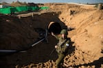 Israeli military spokesman Rear Adm. Daniel Hagari stands at the opening to a tunnel near the border with Israel on Dec. 15, 2023, northern Gaza Strip. The Israeli military said this was the largest tunnel they'd found yet in Gaza.