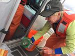 NOAA research fisheries biologist Laurie Weitkamp measures juvenile salmon on a research boat on the Columbia River.