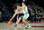 FILE - Gonzaga guard Mario Saint-Supery, left, dribbles past Oregon guard Jackson Shelstad during the first half of an NCAA college basketball game in Portland, Ore., Sunday, Dec. 21, 2025. (AP Photo/Craig Mitchelldyer)
