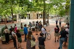 Community members gather in front of The Portland Building in Southwest Portland to rally against the renewal of the Clean & Safe 10-year contract, July 27, 2021.