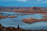 The Wahweap Marina, squeezed by the dropping and encroaching shoreline of Lake Powell on the Colorado River behind the Glen Canyon Dam outside Page, Ariz., on Feb. 20, 2023. The bathtub ring marking the once-high level of the lake is visible on the red rock formations in the distance. Full story here.