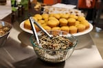A burdock root salad and goldenrod corn bread are out for class participants to try during a class on wild foods preparation during the Indigenous Food Summit at Portland State University on Sept. 9, 2026.