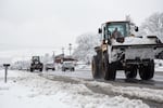 Snow removal trucks drive down Highway 99 in Milwaukie carrying buckets full of snow, Jan. 11, 2017.