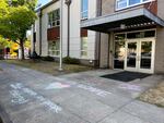 Rainbow chalk messages decorate the sidewalk outside of the entrance to St. Agatha's Catholic School.
