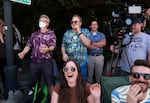 A crowd reacts to the explosion.
