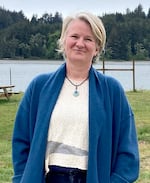 Laura Anderson poses outside the Yaquina Lab in Newport, Ore., on May 2, 2025. Anderson, co-founder of Local Ocean restaurant, purchased the warehouse in 2020 as a processing facility for the restaurant. It's now managed by a local food producers nonprofit, and commercial fishers and others can rent out space and equipment.