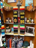Graduation stoles from past Benson Polytechnic High School Escalera cohorts hang in Alberto Plata-Hurtado’s office space on April 17, 2024. Many of Plata-Hurtado’s students have had trouble filling out the FAFSA.