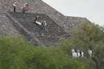 Forensic workers carry the body of a victim down a pyramid after authorities said a gunman opened fire, in Teotihuacan, Mexico, Monday, April 20, 2026.