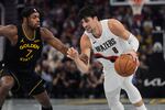 Portland Trail Blazers forward Deni Avdija (8) moves the ball while defended by Golden State Warriors guard Buddy Hield (7) during the first half of an NBA Cup basketball game, Friday, Nov. 21, 2025, in San Francisco. 
