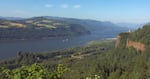 A huge barge navigating the scenic Columbia Gorge