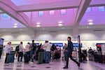 People stand in line at check-in counters at El Paso International Airport, Wednesday. The Federal Aviation Administration closed the airspace around the area for a few hours.