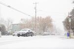 Cars make their way down 13th Avenue in the Sellwood neighborhood during a snowstorm in Portland, on Thursday, Dec. 8, 2016.