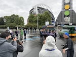 Local officials pose for a photo op in front of Lumen Field on May 13, 2026, after a press conference announcing transit investments for the 2026 World Cup.