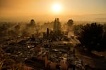 An emergency vehicle drives through a neighborhood devastated by the Eaton Fire, Thursday, Jan. 9, 2025, in Altadena, Calif.