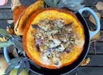 A roasted kuri squash stuffed with nutty, whole-grain breadcrumbs, apples, cranberries and blue cheese