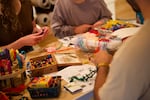 In this provided photo, adults and children craft fairies at an event hosted by OR Unplugged in Portland, Ore. on April 12, 2026.
